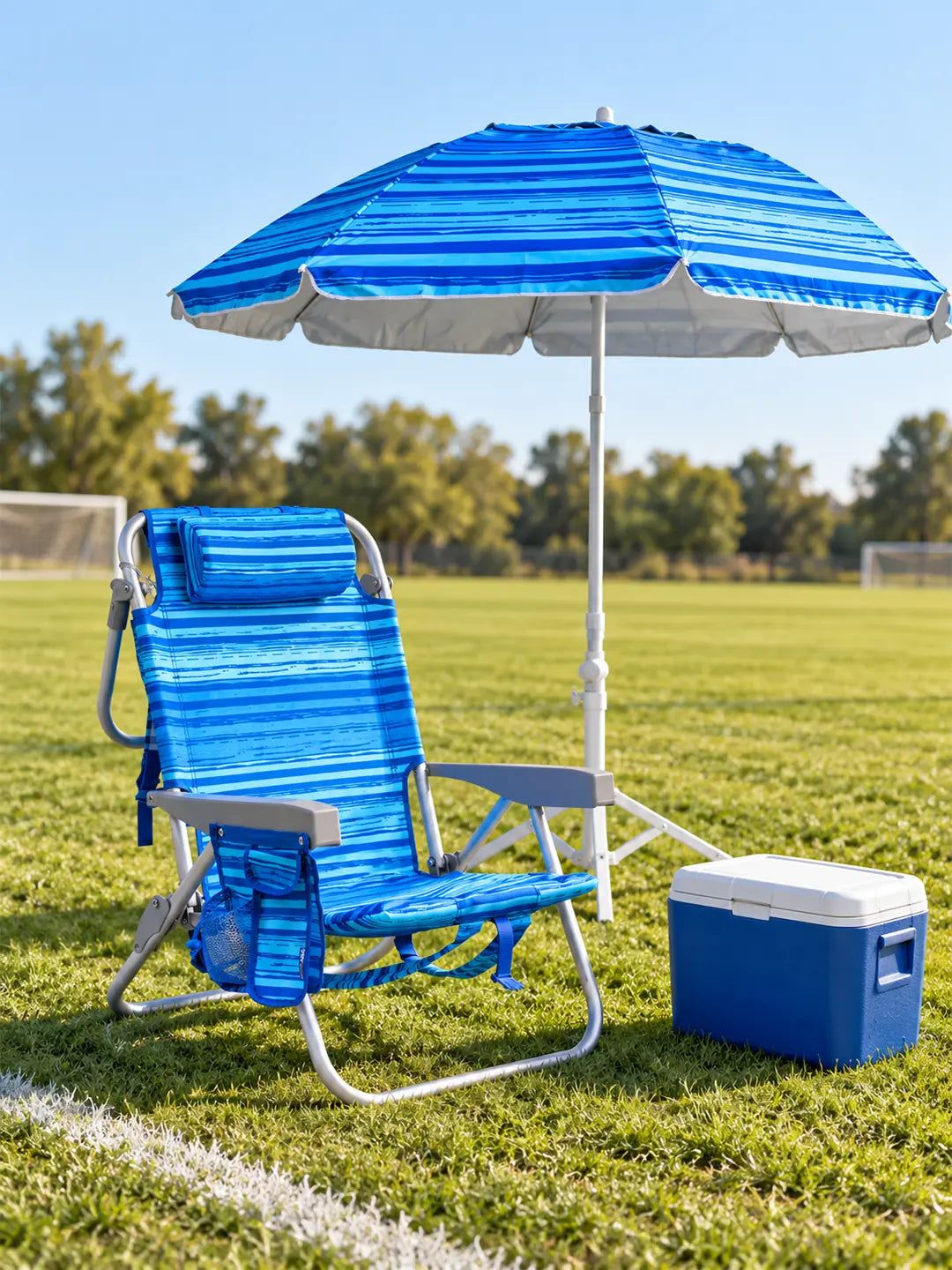 Copa Adult Backpack Chair and 2-in-1 Umbrella with grass stand set up on a youth soccer sideline
