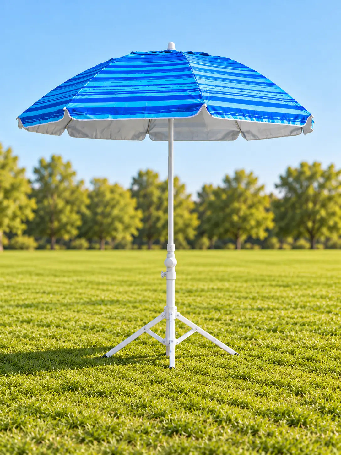 Copa Perfectly Portable 2-in-1 Umbrella standing on its multi-use tripod base on a green grass field